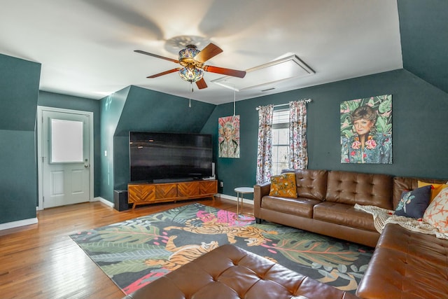 living room with ceiling fan, lofted ceiling, and light hardwood / wood-style flooring