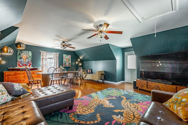 living room with vaulted ceiling, ceiling fan, and light hardwood / wood-style flooring