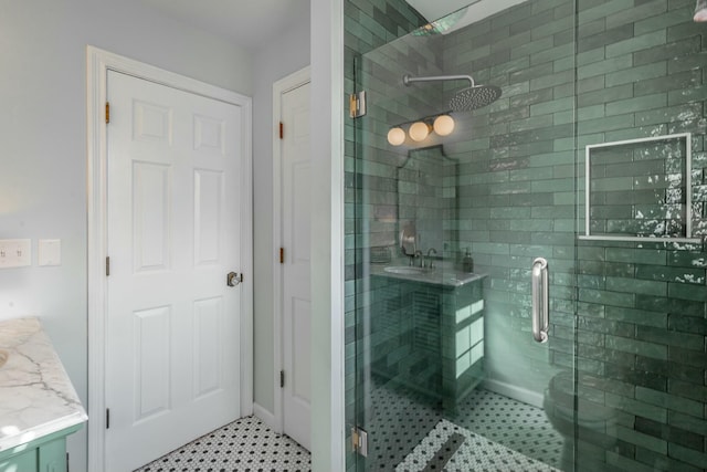 bathroom with vanity and a shower with shower door