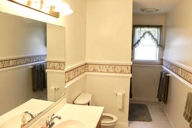 bathroom with vanity and toilet