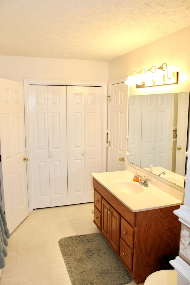 bathroom featuring vanity and a textured ceiling