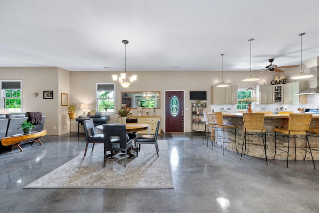 dining room featuring ceiling fan with notable chandelier