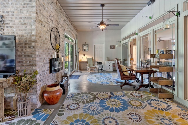 interior space featuring concrete flooring and ceiling fan