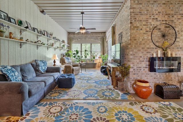 living room featuring ceiling fan and brick wall