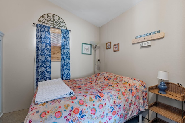 bedroom with lofted ceiling and carpet flooring