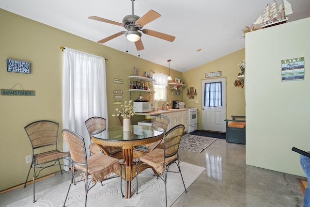 dining space with lofted ceiling, sink, concrete floors, and ceiling fan