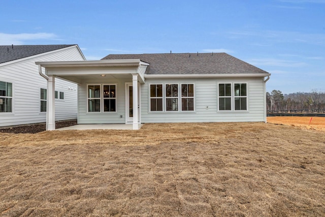 rear view of property with a lawn and a patio area