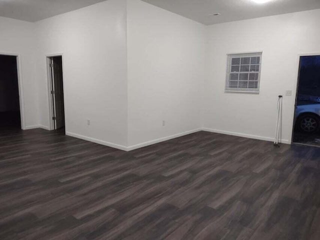 spare room with dark wood-type flooring