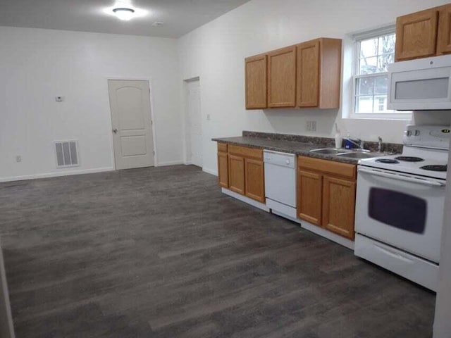 kitchen featuring sink, white appliances, and dark hardwood / wood-style floors