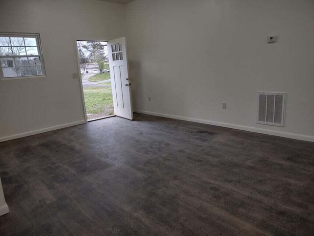 unfurnished room with dark hardwood / wood-style flooring