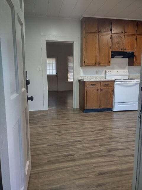 kitchen featuring electric stove and dark hardwood / wood-style flooring