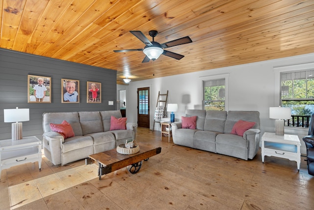 living room featuring ceiling fan, wooden ceiling, plenty of natural light, and light wood-type flooring