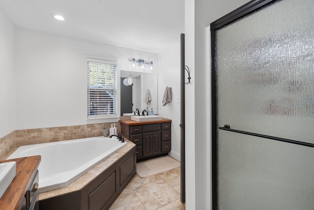 bathroom with tile patterned floors, vanity, and independent shower and bath