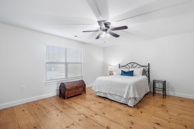 bedroom with ceiling fan and hardwood / wood-style floors