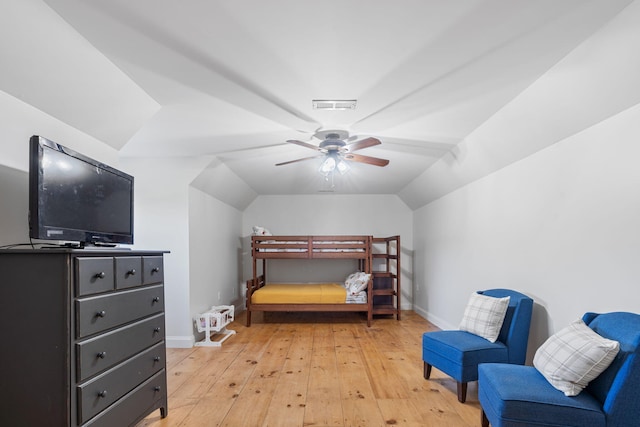 bedroom featuring ceiling fan, vaulted ceiling, and light wood-type flooring