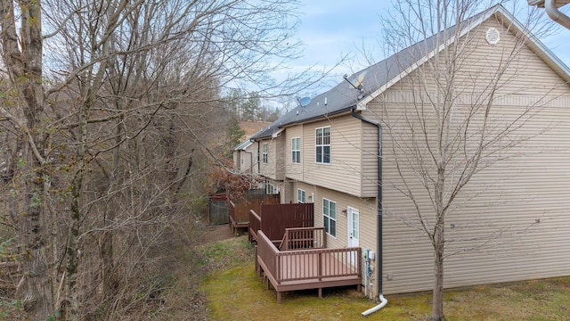 rear view of property featuring a deck