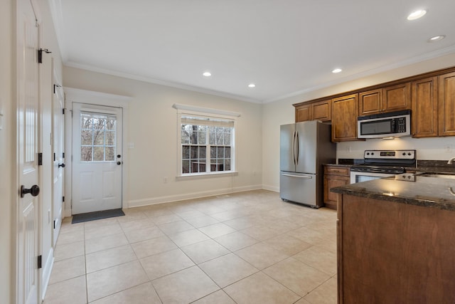 kitchen with crown molding, appliances with stainless steel finishes, and sink