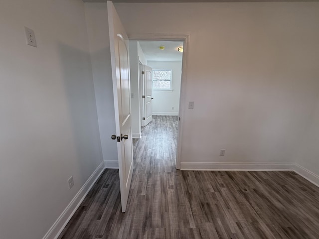 hallway with dark hardwood / wood-style floors