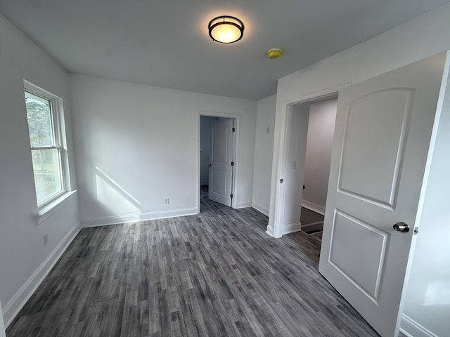 unfurnished bedroom featuring dark hardwood / wood-style flooring