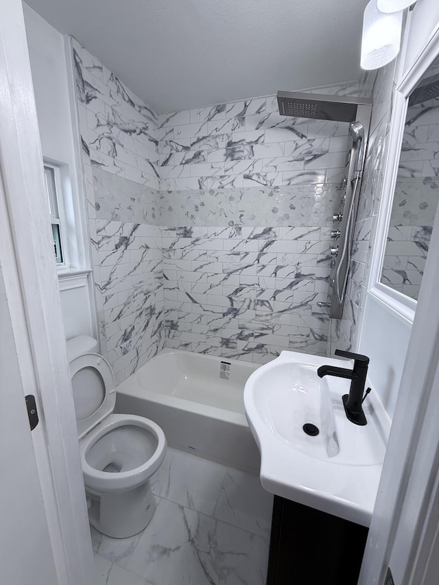 full bathroom featuring vanity, toilet, and tiled shower / bath combo