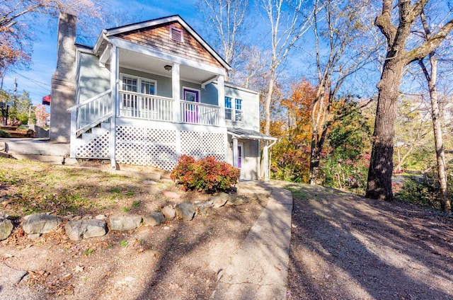 view of front of home with a porch and a chimney