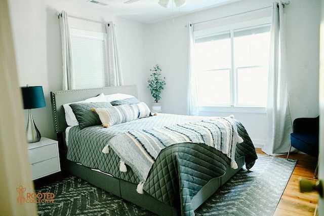 bedroom with visible vents and wood finished floors