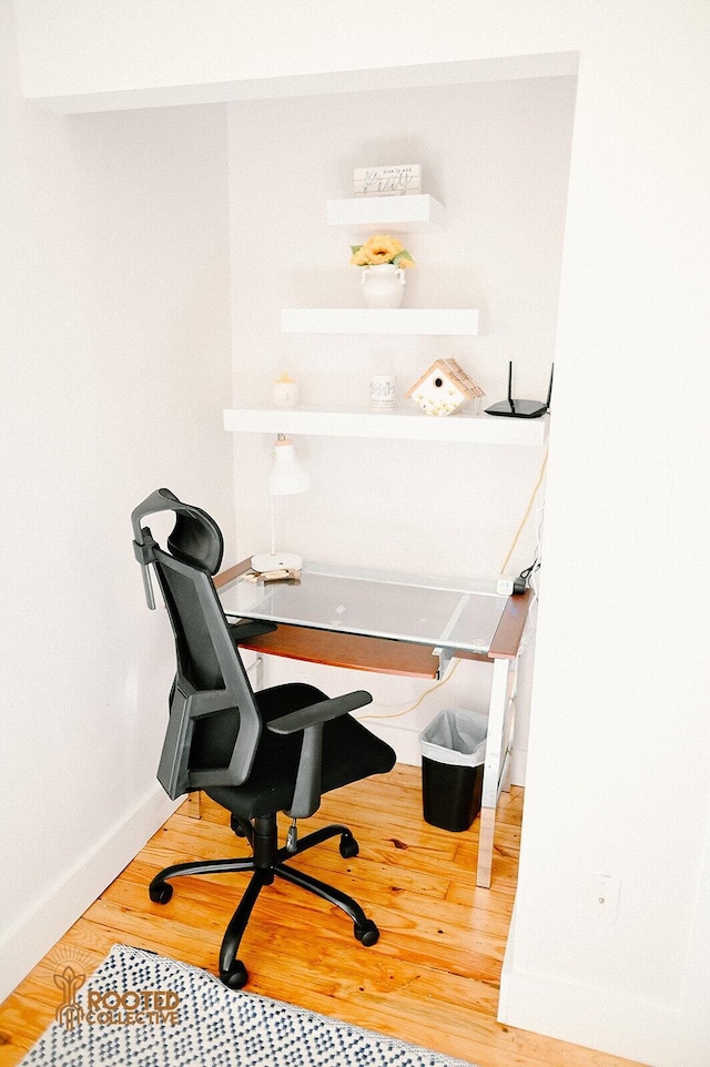 home office with baseboards and wood finished floors