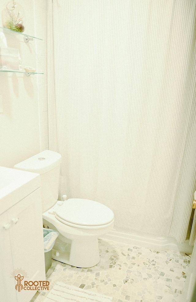 bathroom with tile patterned flooring and toilet