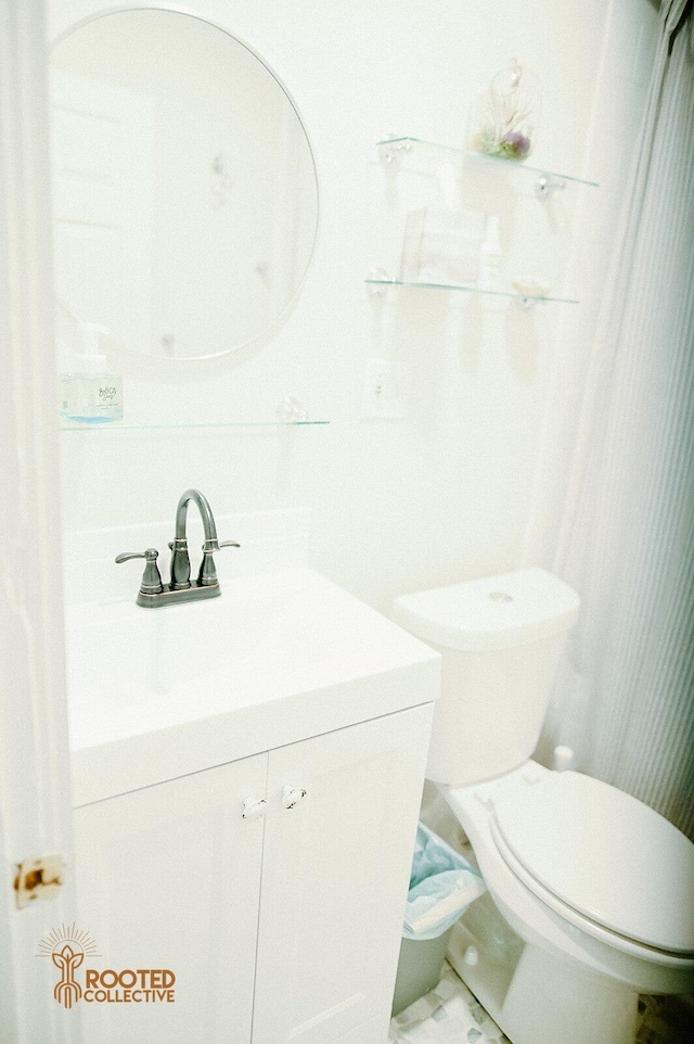 bathroom featuring vanity and toilet