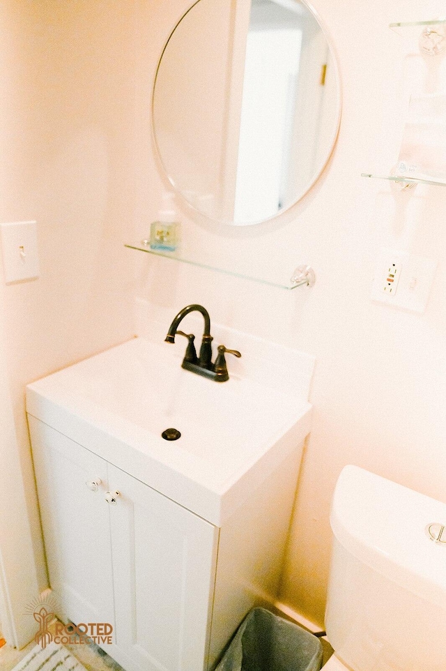 bathroom featuring toilet and vanity