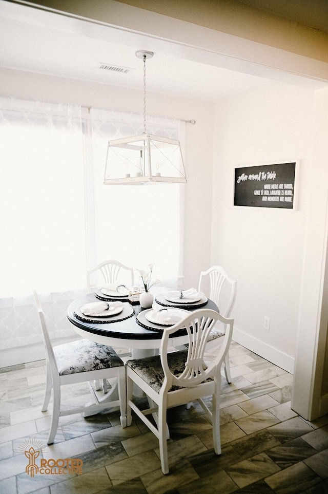 dining room featuring baseboards and visible vents