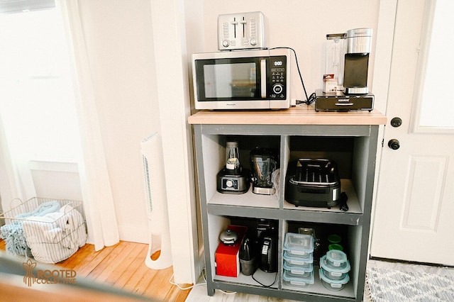 interior space featuring stainless steel microwave and wood finished floors