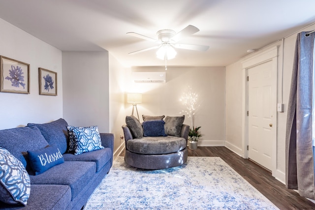 living room with dark wood finished floors, baseboards, a wall mounted AC, and a ceiling fan