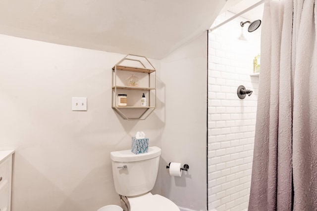 full bath featuring toilet and a tile shower