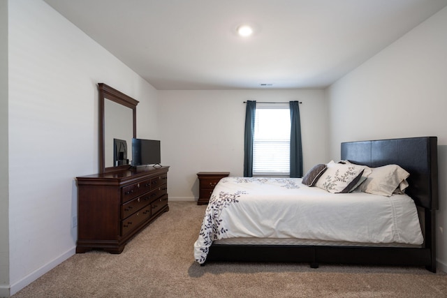 bedroom with light colored carpet