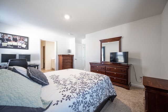 carpeted bedroom with ensuite bath