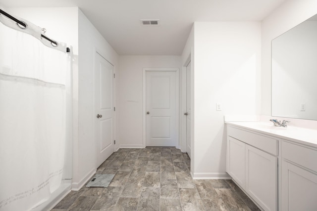 bathroom featuring vanity and curtained shower