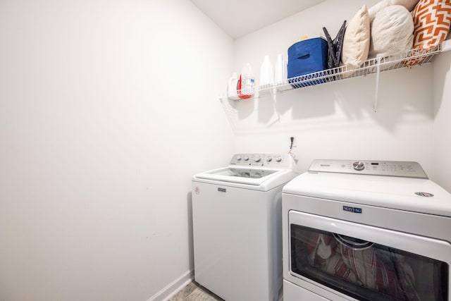 washroom with washing machine and clothes dryer