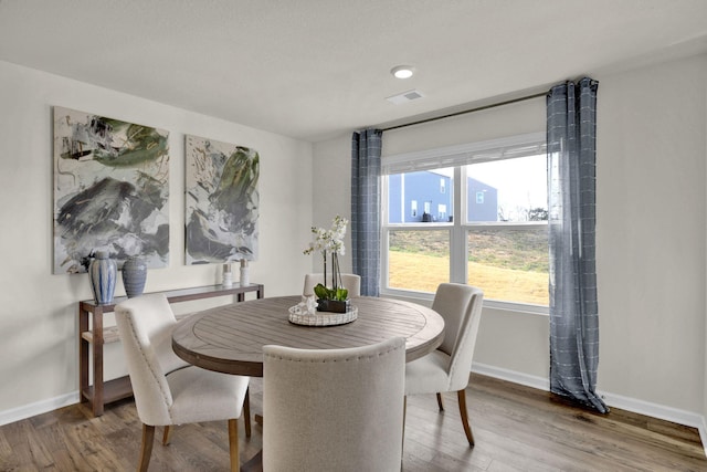 dining space featuring hardwood / wood-style floors