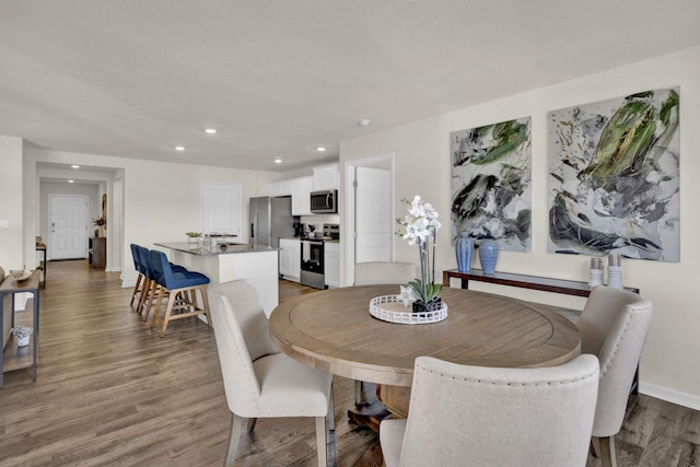 dining room with hardwood / wood-style flooring