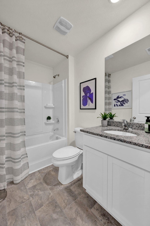 full bathroom with shower / bath combo, vanity, a textured ceiling, and toilet