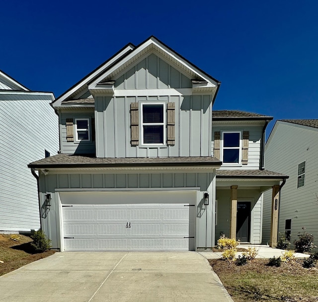 view of front facade featuring concrete driveway, an attached garage, and board and batten siding