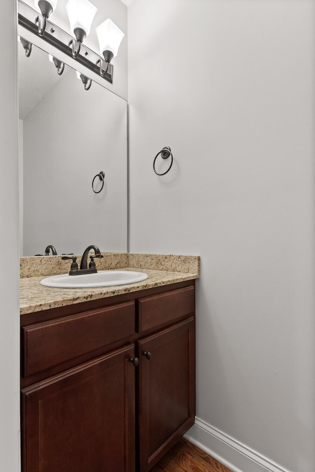 bathroom featuring hardwood / wood-style flooring and vanity