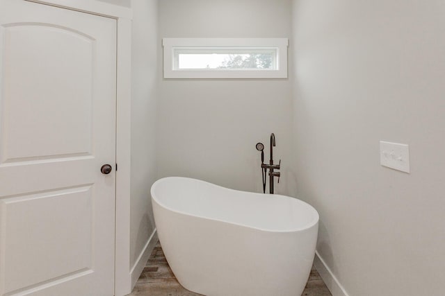 bathroom featuring a bath and hardwood / wood-style flooring