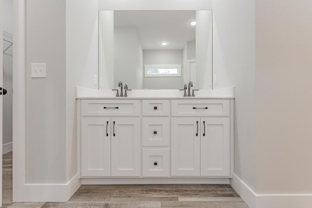 bathroom featuring vanity and wood-type flooring