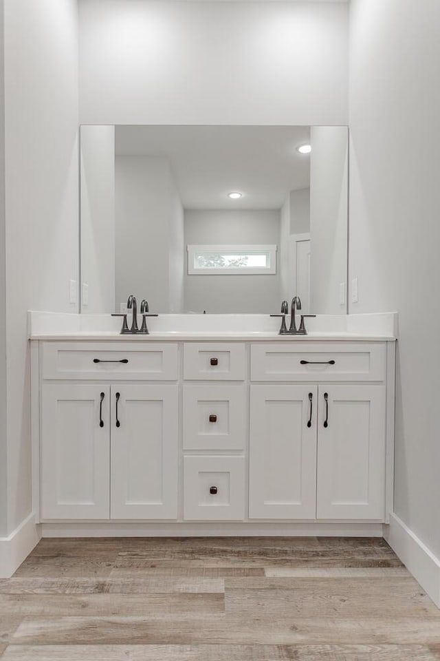 bathroom with vanity and hardwood / wood-style flooring