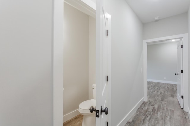 corridor with light hardwood / wood-style flooring