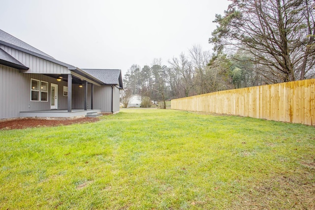 view of yard with a patio area and ceiling fan