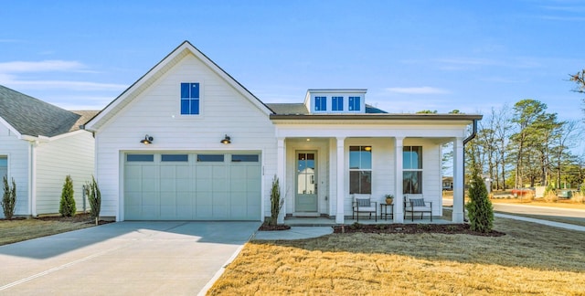 view of front of property with a porch, a garage, and a front yard