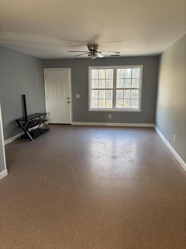 interior space with ceiling fan